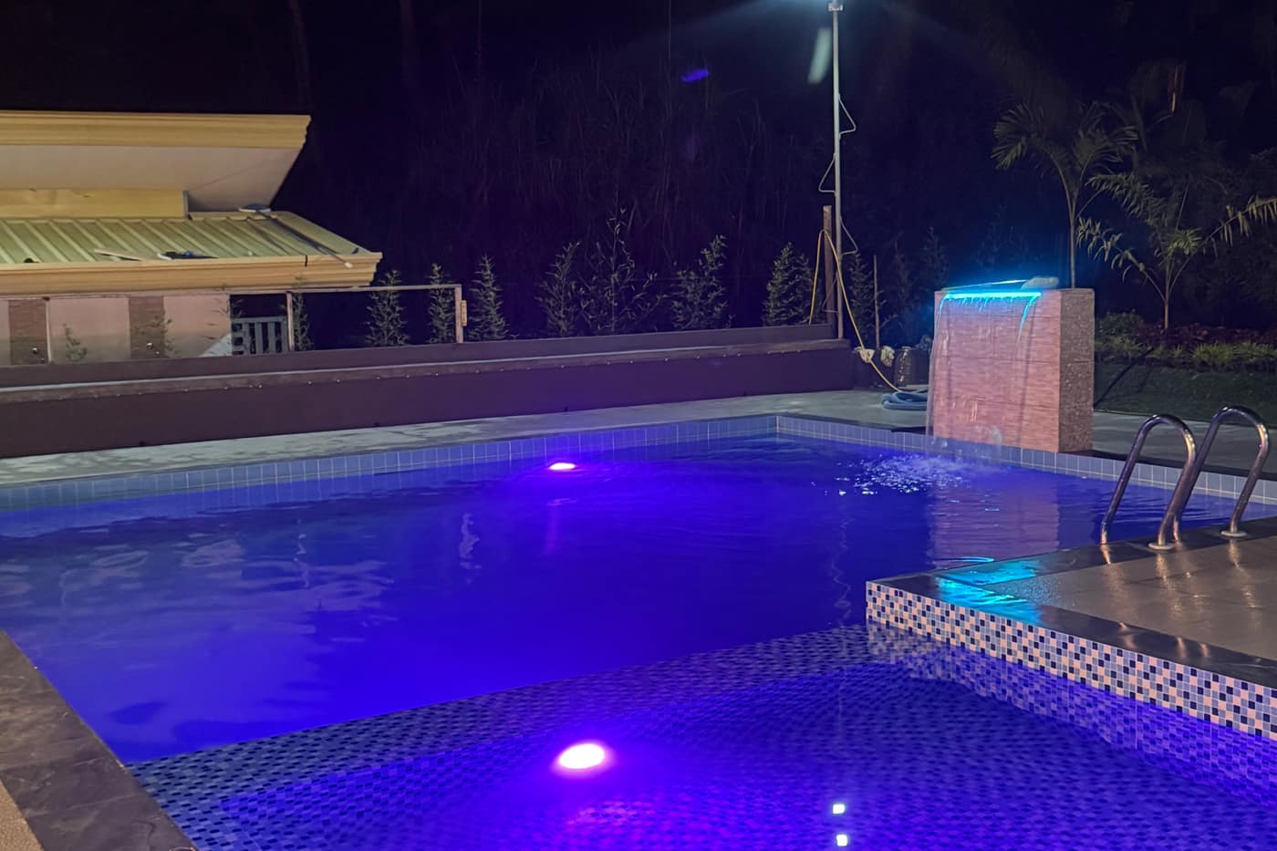 Pool glowing blue at night