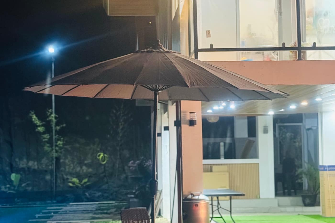 Garden umbrella and tropical plants in the tea garden