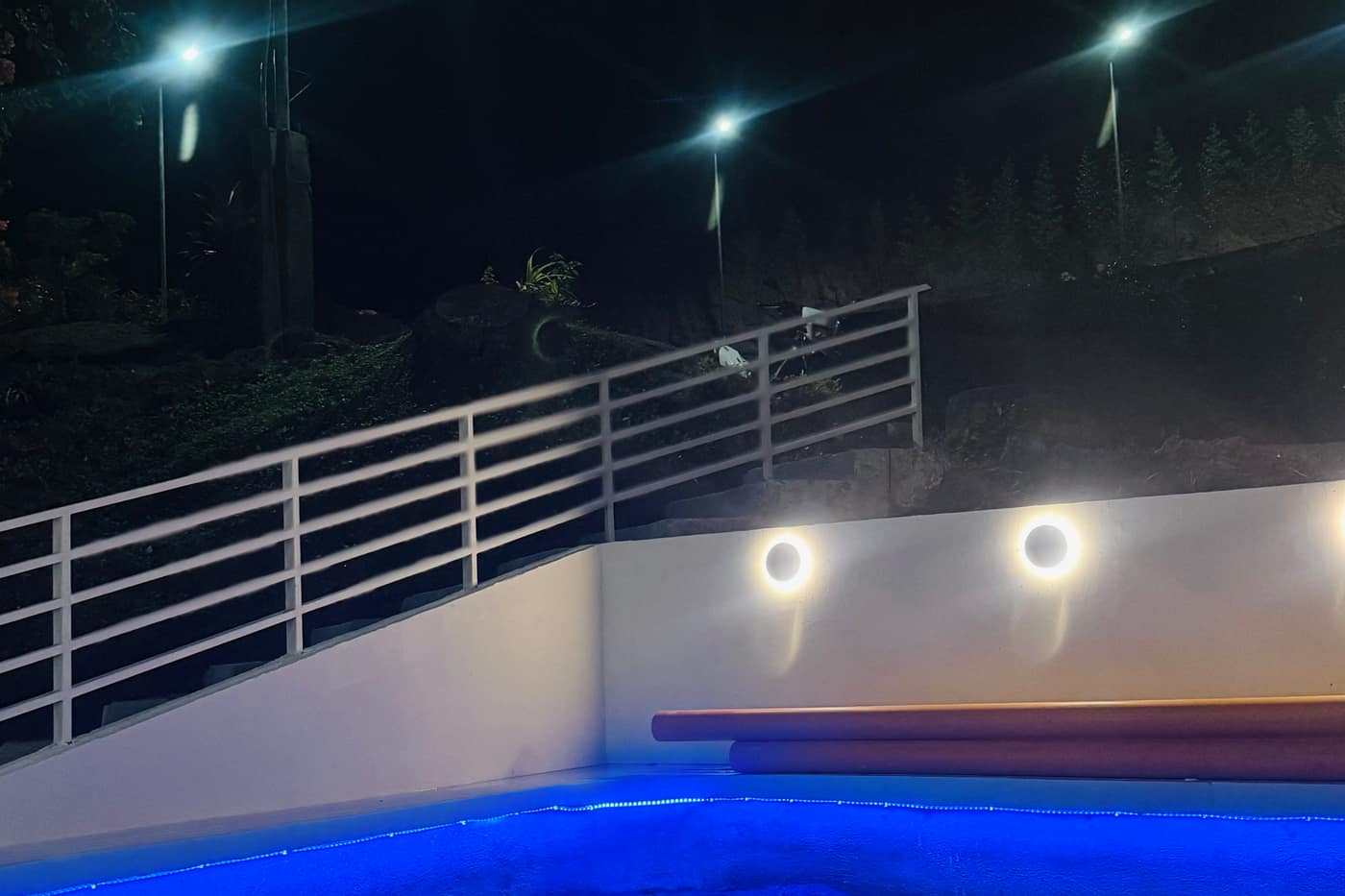 Poolside stairs and ambient lighting at night